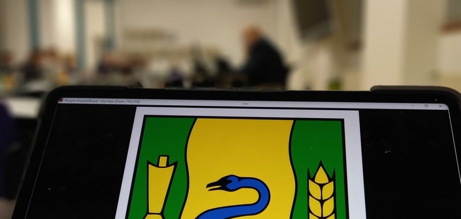 Das Wappen der Stadt Gronau mit dem Ratssaal im Hintergrund