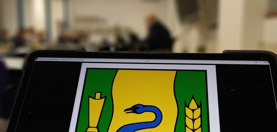 Das Wappen der Stadt Gronau mit dem Ratssaal im Hintergrund