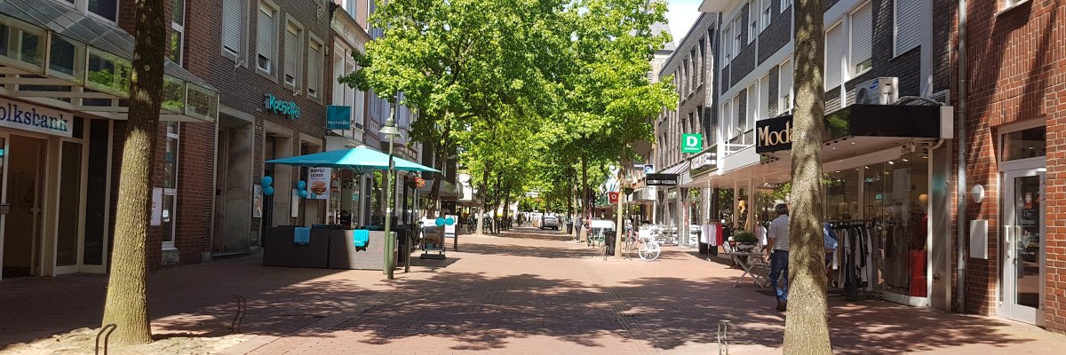 Innenstadt Gronau  Blick in die Fußgängerzone der Neustraße. Links im Bild ist das Geschäft Kochlöffel zu sehen, rechts Deichmann. Vereinzelt laufen Personen durch die Innenstadt.