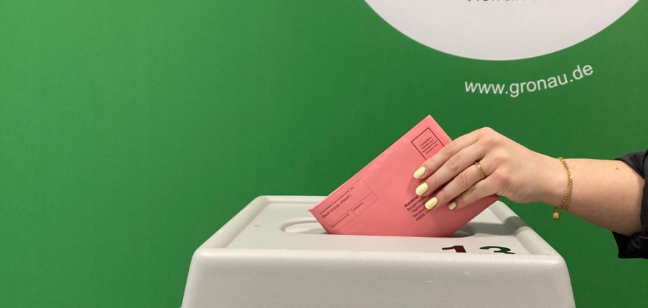 Ein Wahlbrief wird in die Wahlurne geworfen