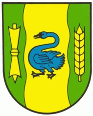 Das Wappen der Stadt Gronau. In Grün ein breiter gelber mit einem schwarz bewehrten blauen Schwan belegter Wellenpfahl, begleitet vorn von einer gelben Spule, hinten von einer gelben Ähre.