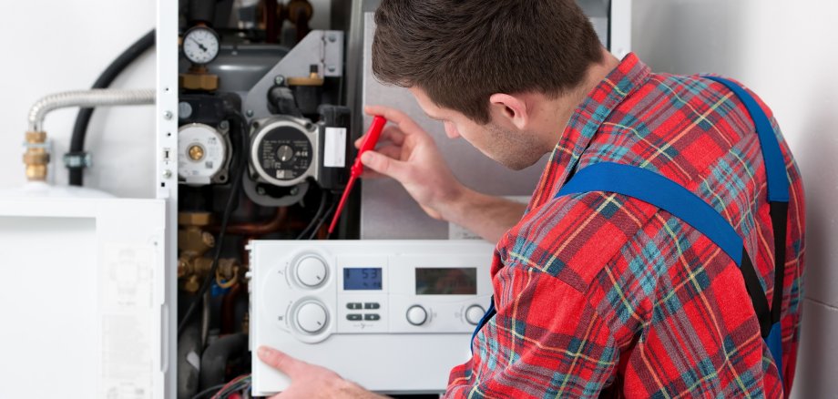 Technician servicing heating boiler