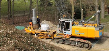 Spezialkran läßt Edelstahlrohr in den Boden ein