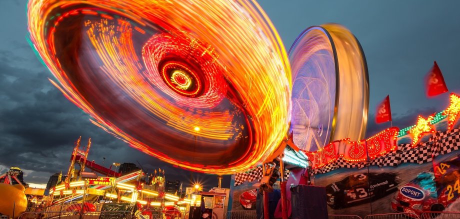 Ein beleuchteter Jahrmarkt am Abend.