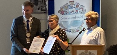 Bürgermeister Rainer Doetkotte (l.) überreicht den Integrationspreis an Roswitha Kolhoff im Beisein von Ahmet Sezer, Integrationsbeauftragter der Stadt Gronau