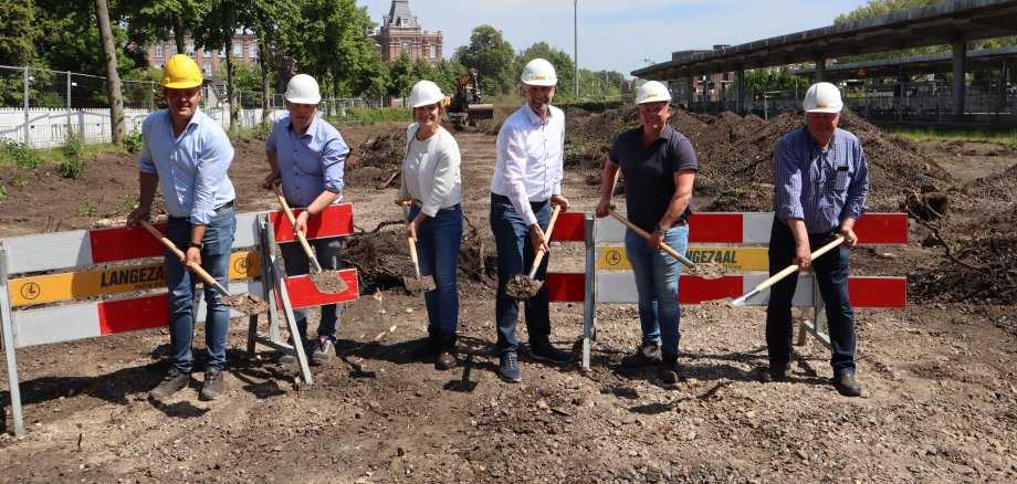 Eine Gruppe mit Spaten auf dem Baugrundstück an der Losserstraße