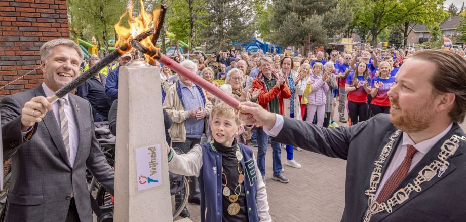  Bürgermeister Rainer Doetkotte, Bürgermeister Jeroen Diepemaat und Kinderbürgermeisters Gijs Evers entzünden gemeinsam die „Freiheitsflamme“.